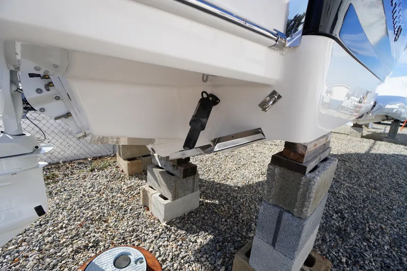 Slide: The Image of 2026 Chaparral 250 OSX boat hull on blocks, showcasing sleek design and construction. - 56