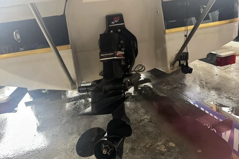 Slide: The Image of 2002 Regal 2100 LSR boat with MerCruiser outdrive in a garage setting. - 10