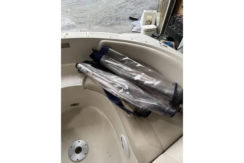 Slide: The Image of 2002 Regal 2100 LSR boat interior with clear plastic covers on seats. - 11