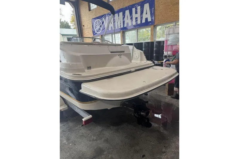 Slide: The Image of 2002 Regal 2100 LSR boat in garage, Yamaha banner visible in background. - 12