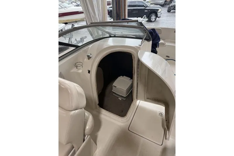 Slide: The Image of 2002 Regal 2100 LSR boat interior with open storage compartment and seating. - 14