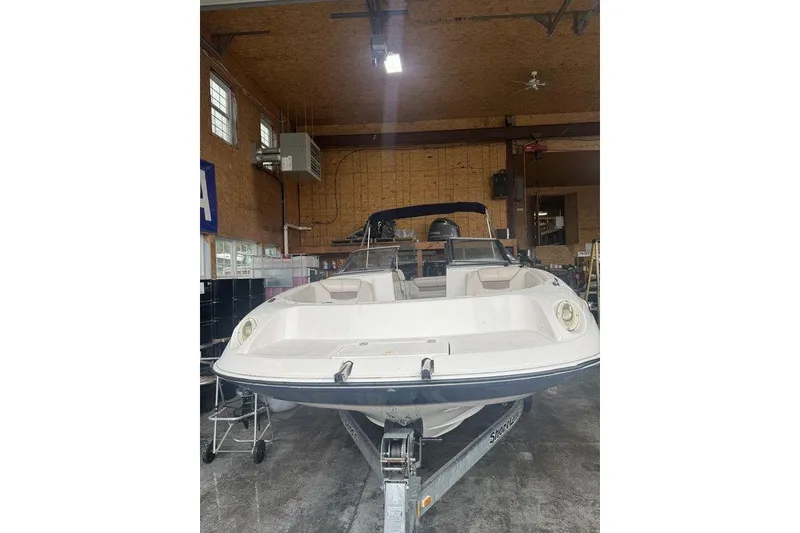 Slide: The Image of 2002 Regal 2100 LSR boat in a garage, front view. - 4