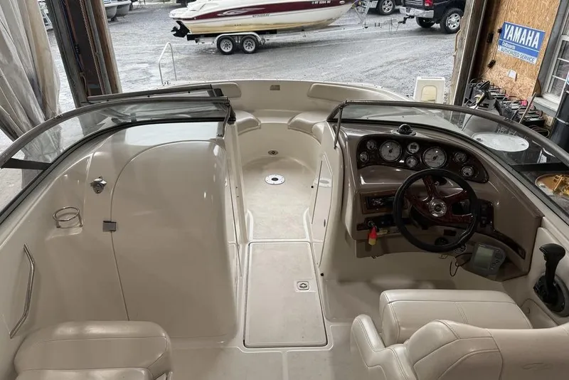 Slide: The Image of 2002 Regal 2100 LSR boat interior with steering wheel and dashboard in a garage setting. - 7