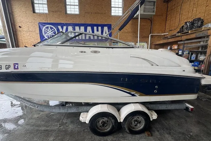 Slide: The Image of 2002 Regal 2100 LSR boat on trailer in garage with Yamaha banner. - 8