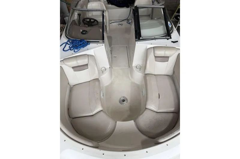 Slide: The Image of 2002 Regal 2100 LSR boat interior with white seating and steering wheel. - 9