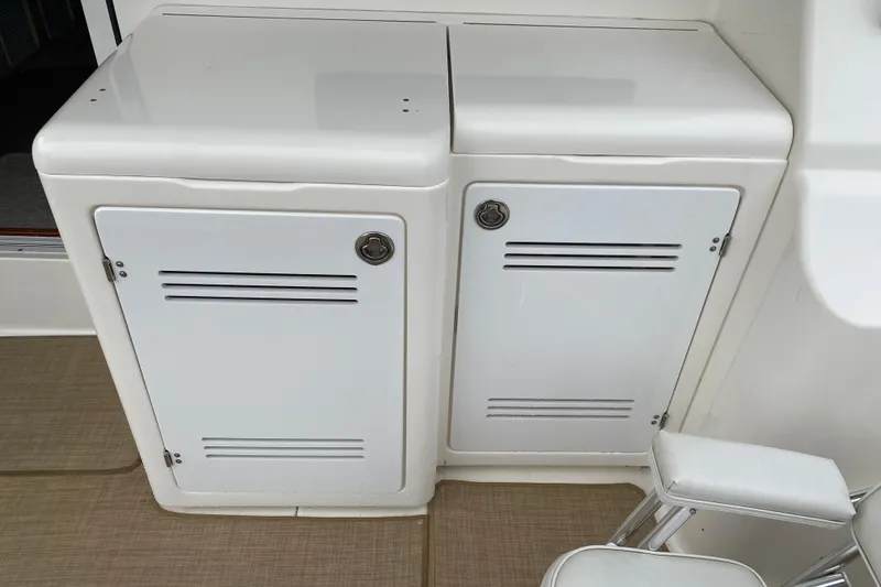 Slide: The Image of White storage cabinets on a 2007 Silverton 36 Convertible boat deck. - 11