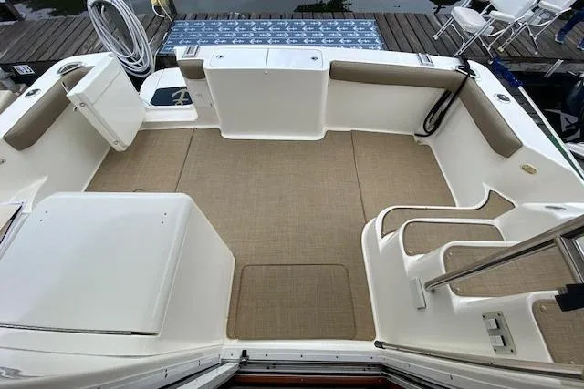 Slide: The Image of 2007 Silverton 36 Convertible boat deck with seating and storage, dockside view. - 13