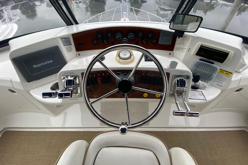 Slide: The Image of 2007 Silverton 36 Convertible helm with steering wheel, controls, and navigation equipment. - 17