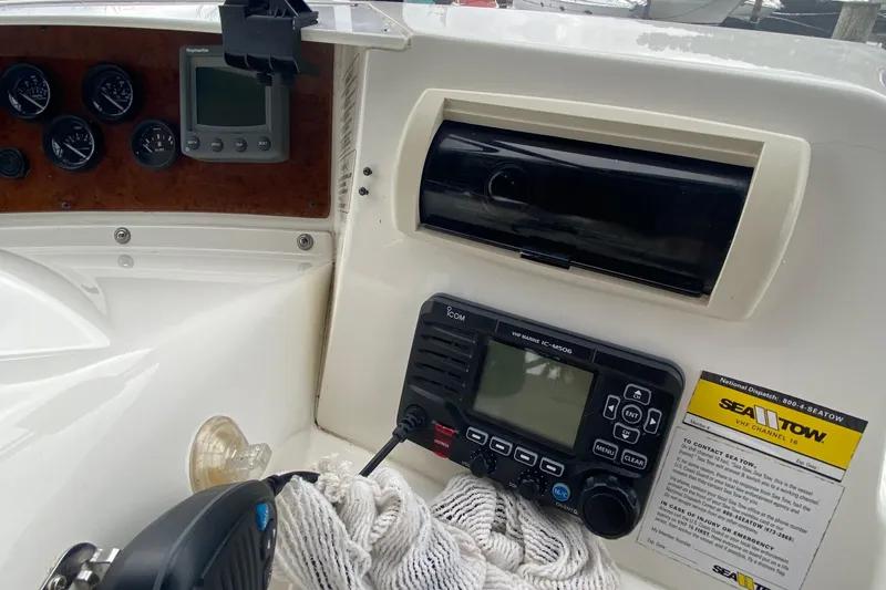 Slide: The Image of 2007 Silverton 36 Convertible boat dashboard with gauges, radio, and Sea Tow information. - 19