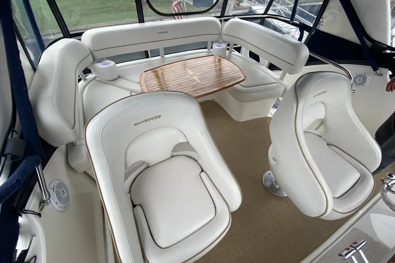 Slide: The Image of Luxurious seating area on a 2007 Silverton 36 Convertible yacht with elegant white upholstery. - 21