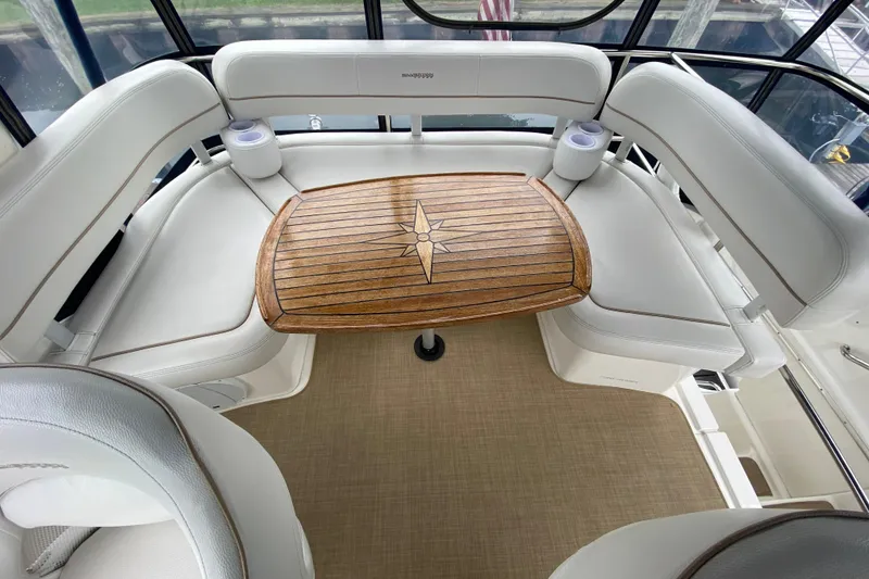 Slide: The Image of Luxurious seating area on 2007 Silverton 36 Convertible yacht with wooden table. - 22