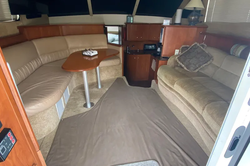 Slide: The Image of Interior of 2007 Silverton 36 Convertible yacht with cozy seating and wooden table. - 23