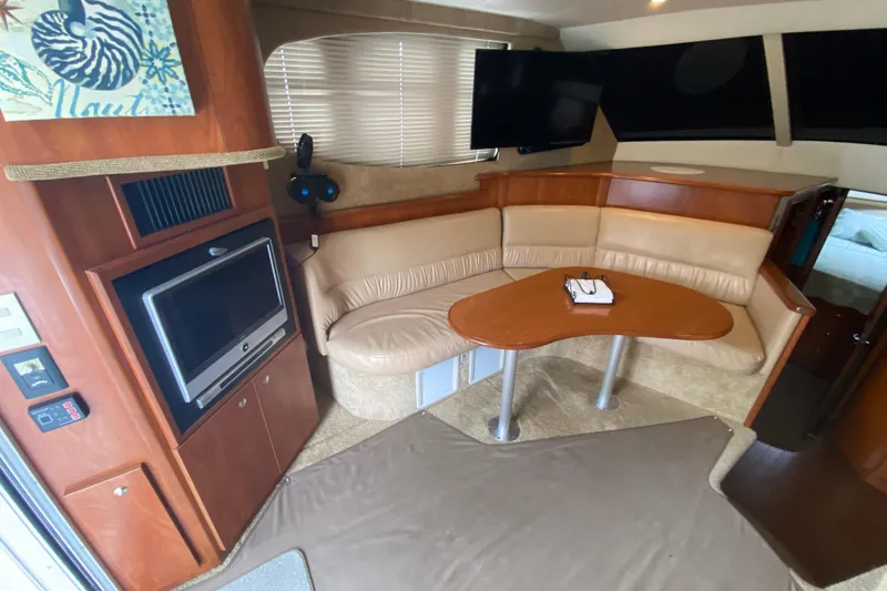 Slide: The Image of Interior of 2007 Silverton 36 Convertible yacht with cozy seating and entertainment area. - 25
