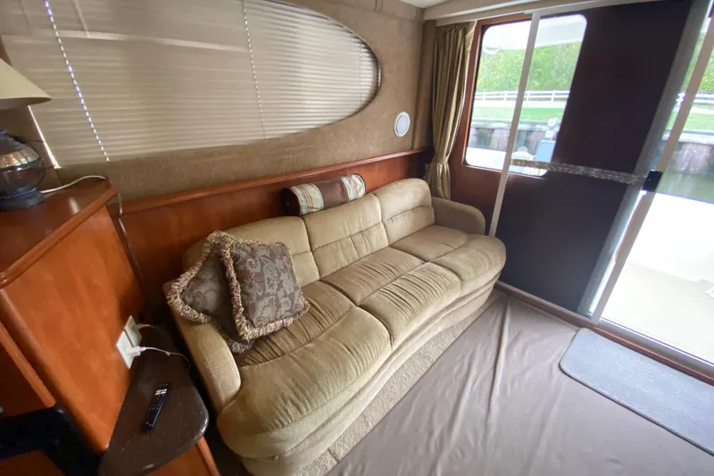 Slide: The Image of Interior of 2007 Silverton 36 Convertible yacht with beige sofa and decorative pillows. - 28