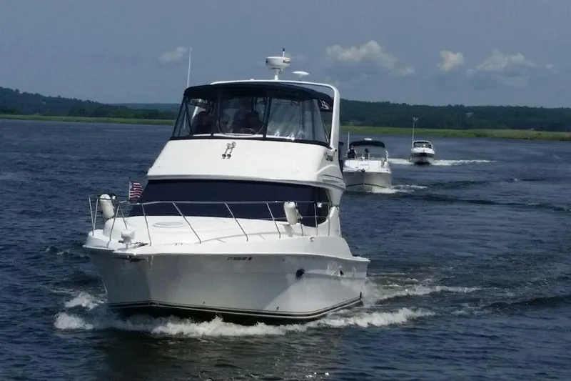 Slide: The Image of 2007 Silverton 36 Convertible yacht cruising on open water with scenic background. - 3