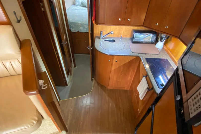Slide: The Image of Interior of 2007 Silverton 36 Convertible yacht with compact kitchen and cozy cabin. - 30