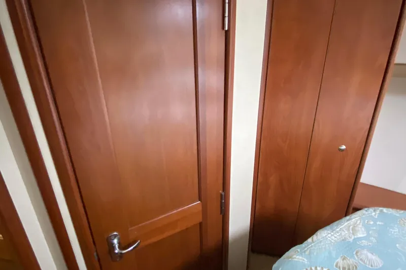 Slide: The Image of Interior of 2007 Silverton 36 Convertible with wooden doors and patterned bedding. - 38