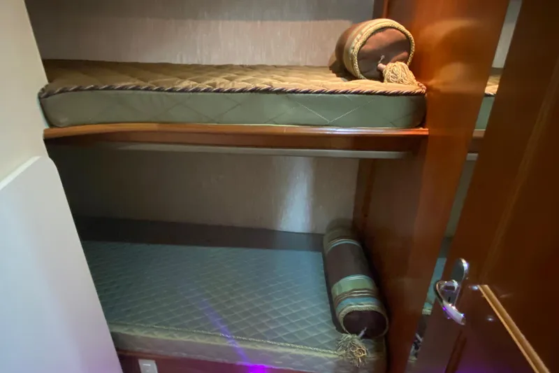 Slide: The Image of 2007 Silverton 36 Convertible yacht interior with cozy bunk beds and elegant wood finish. - 39