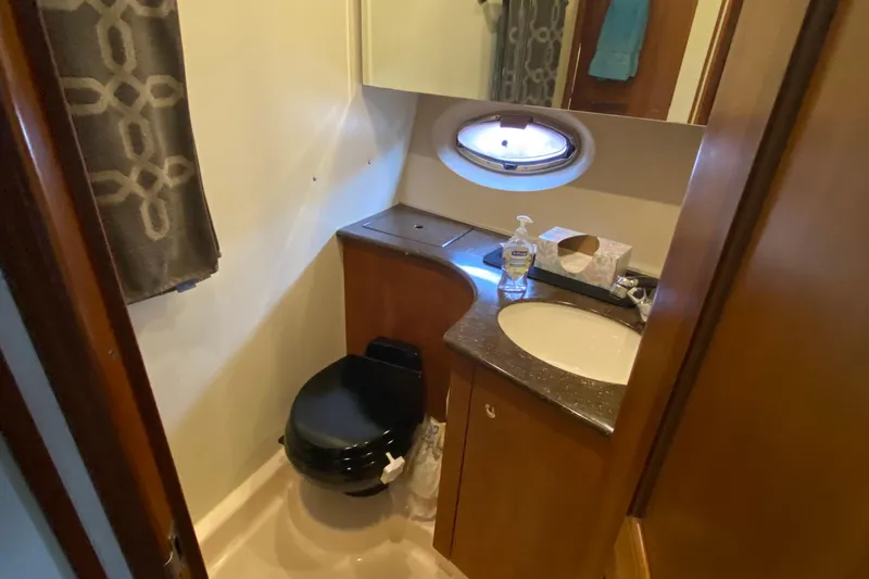 Slide: The Image of Bathroom interior of 2007 Silverton 36 Convertible yacht with sink and porthole window. - 40