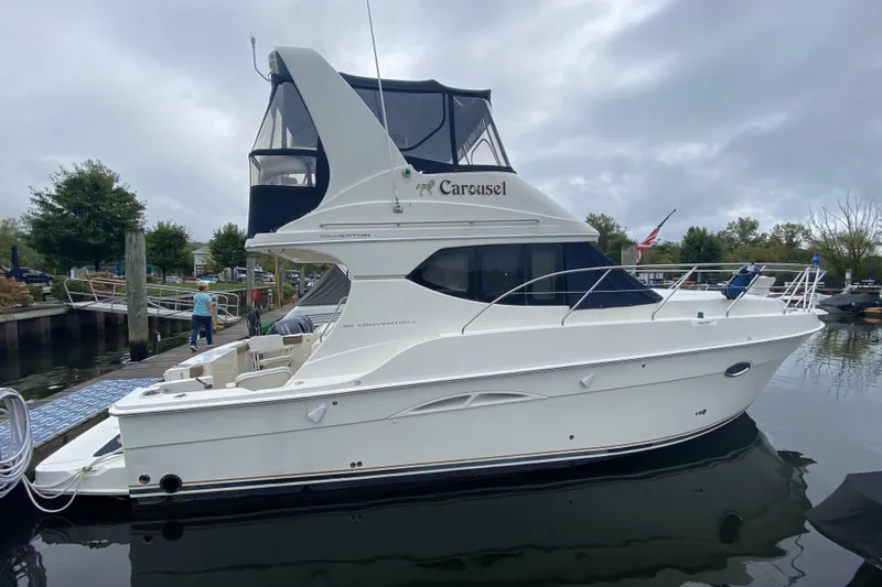 Slide: The Image of 2007 Silverton 36 Convertible yacht docked at marina, overcast sky. - 5
