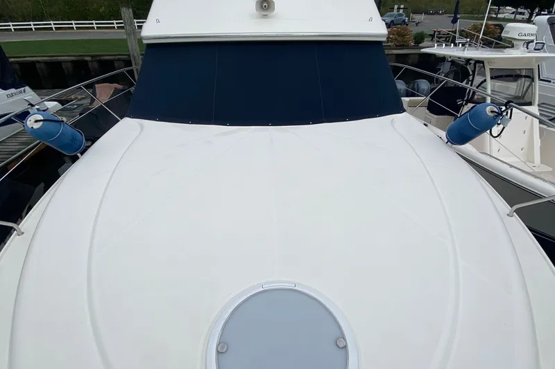 Slide: The Image of 2007 Silverton 36 Convertible yacht with blue fenders docked at marina. - 6