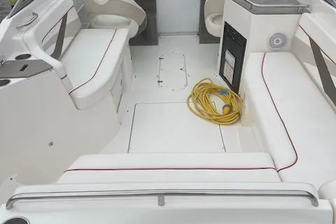 Slide: The Image of 2008 Rinker 282 Captiva Cuddy interior with white seating and coiled yellow rope. - 10