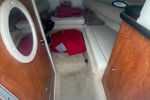 Slide: The Image of 2008 Rinker 282 Captiva Cuddy cabin interior with seating and storage. - 4