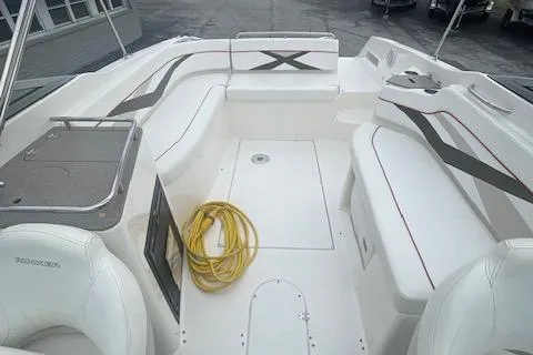 Slide: The Image of 2008 Rinker 282 Captiva Cuddy boat interior with white seating and a coiled yellow rope. - 5