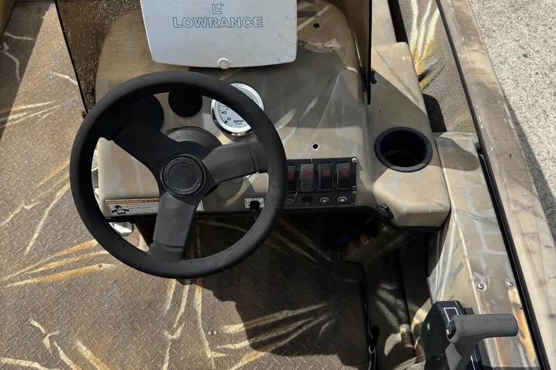 Slide: The Image of Steering console of 2011 SeaArk XV180 CC boat with Lowrance system and control panel. - 14