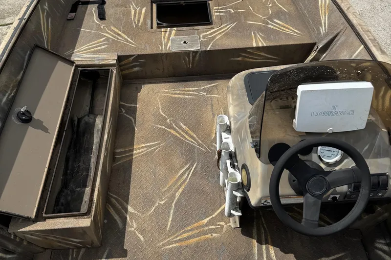 Slide: The Image of 2011 SeaArk XV180 CC boat interior with camouflage design and Lowrance navigation system. - 16