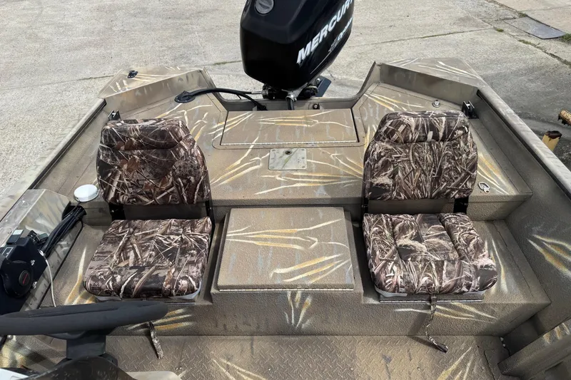 Slide: The Image of 2011 SeaArk XV180 CC boat interior with camouflage seats and Mercury engine. - 21