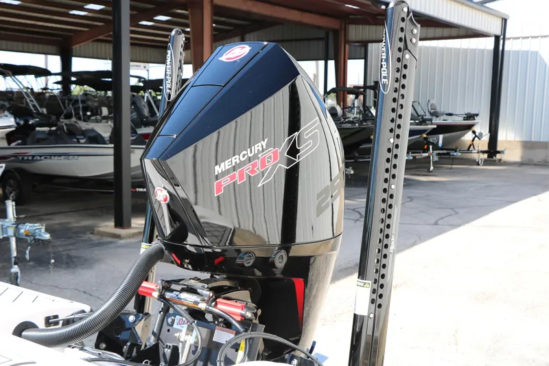 Slide: The Image of 2025 Caymas CX 21 PRO with Mercury Pro XS engine in a boat showroom. - 10