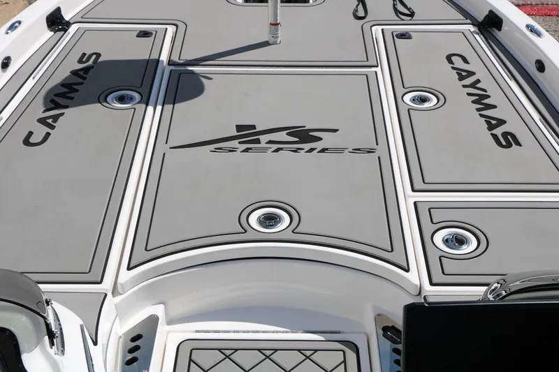Slide: The Image of 2025 Caymas CX 21 PRO boat deck with XS Series branding, featuring sleek design and storage compartments. - 18