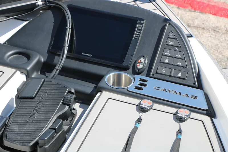 Slide: The Image of 2025 Caymas CX 21 PRO boat dashboard with Garmin electronics and control panel. - 21