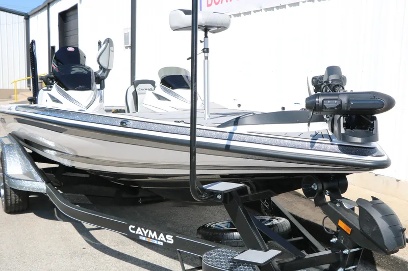 Slide: The Image of 2025 Caymas CX 21 PRO boat on trailer, sleek design, outdoor setting. - 6