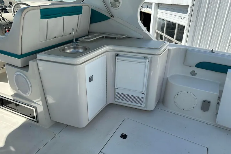Slide: The Image of 1992 Regal Commodore 400 boat interior with sink, seating, and storage. - 10