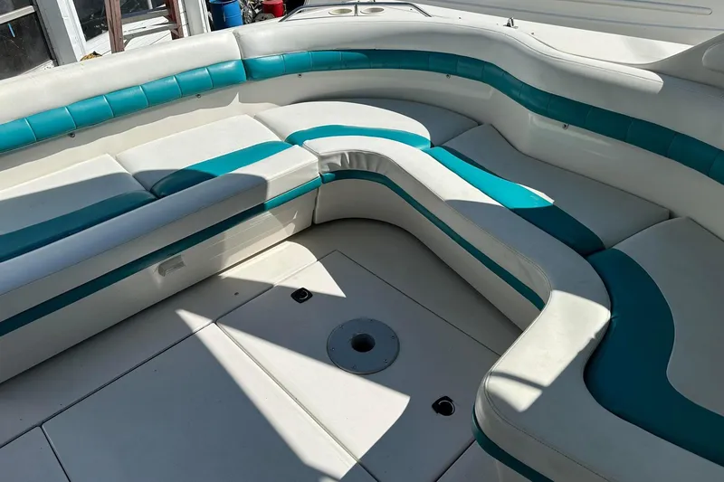 Slide: The Image of Interior seating of a 1992 Regal Commodore 400 boat with teal and white upholstery. - 12
