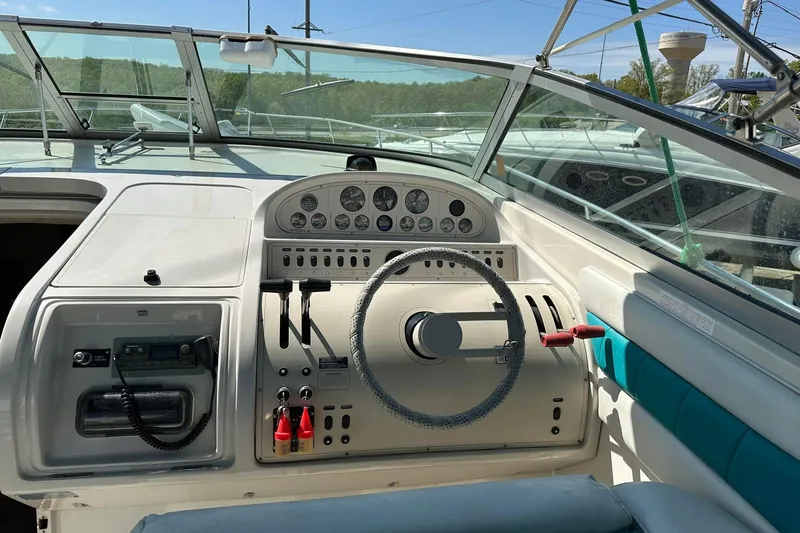 Slide: The Image of 1992 Regal Commodore 400 boat dashboard with steering wheel and control panel. - 15