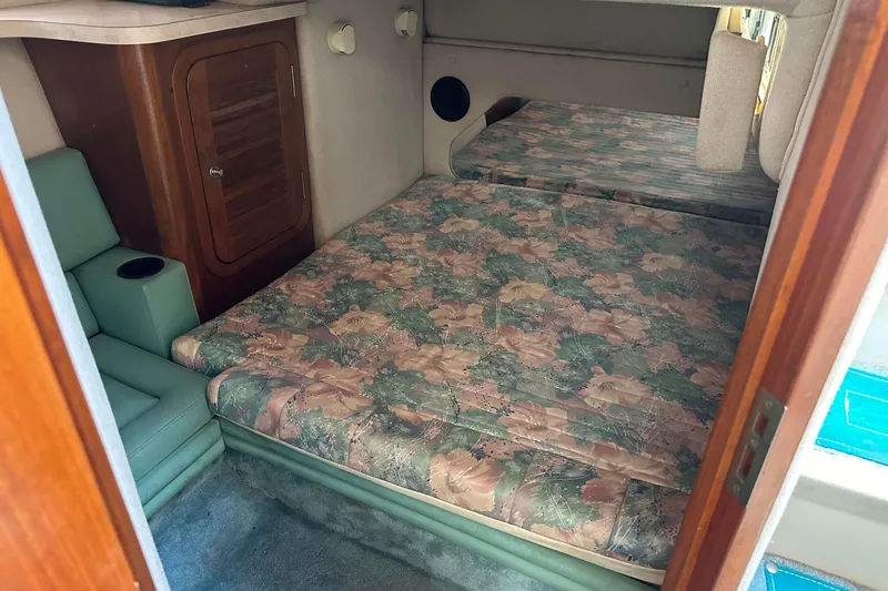 Slide: The Image of Interior cabin of 1992 Regal Commodore 400 with floral-patterned bedding and wooden cabinetry. - 20