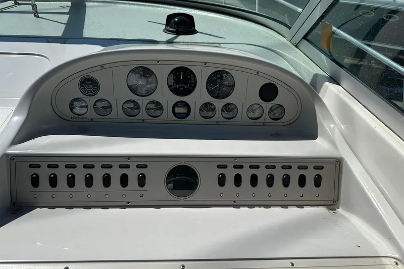 Slide: The Image of 1992 Regal Commodore 400 boat dashboard with gauges and control panel. - 23