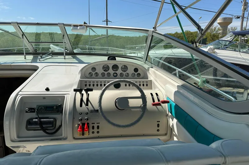 Slide: The Image of 1992 Regal Commodore 400 boat dashboard with steering wheel and control panel. - 24