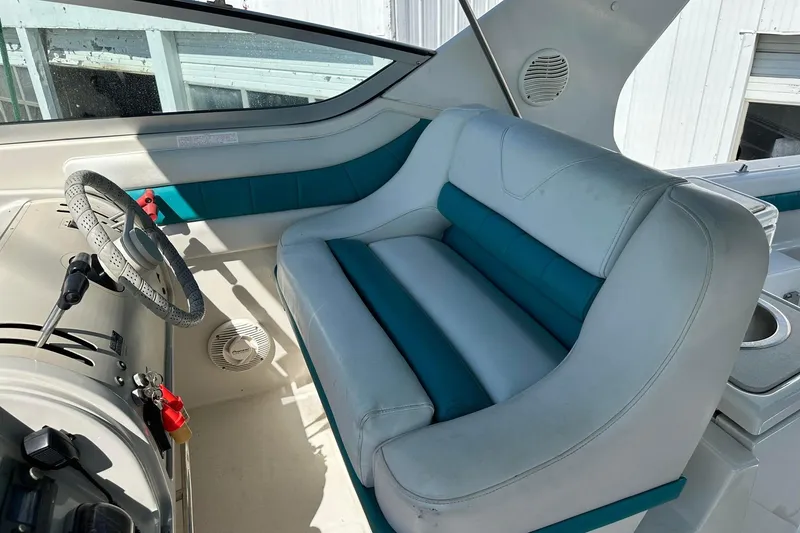 Slide: The Image of Interior of a 1992 Regal Commodore 400 boat with teal and white seating. - 27