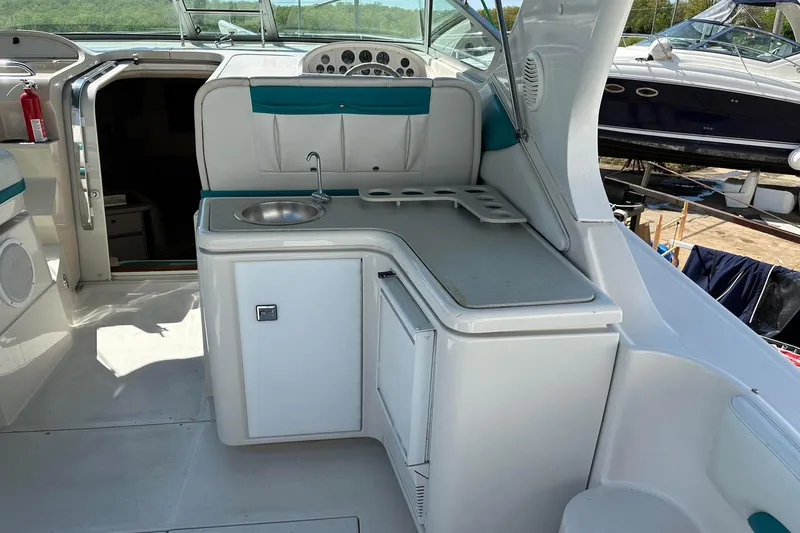 Slide: The Image of Interior of a 1992 Regal Commodore 400 boat with kitchenette and seating area. - 28