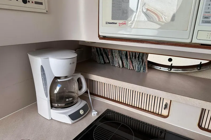 Slide: The Image of Coffee maker and microwave in a 1992 Regal Commodore 400 kitchen area. - 29