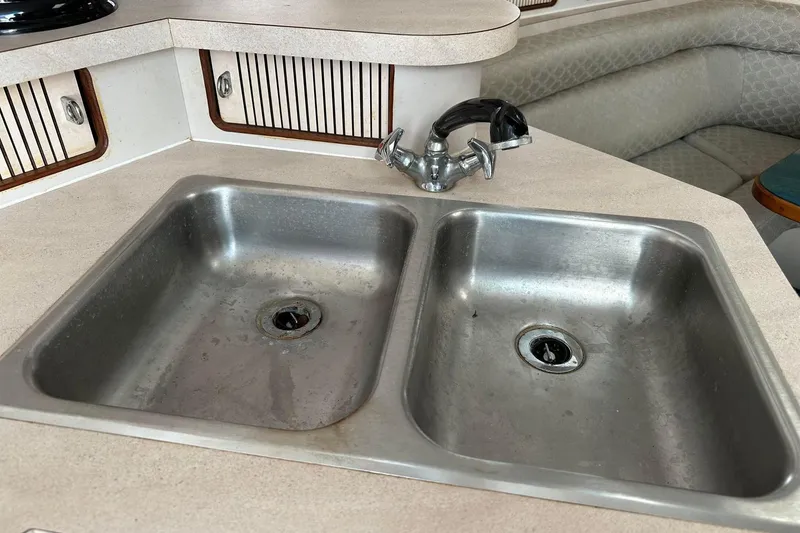 Slide: The Image of Double sink in 1992 Regal Commodore 400 boat kitchen with faucet and countertop. - 30