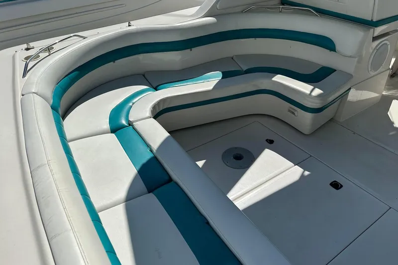 Slide: The Image of 1992 Regal Commodore 400 boat interior with white and teal seating arrangement. - 32