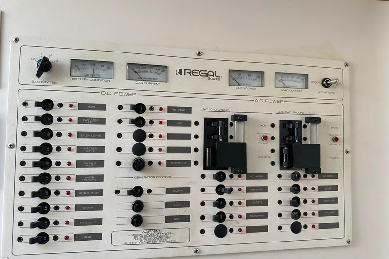 Slide: The Image of Control panel of a 1992 Regal Commodore 400 boat, featuring DC and AC power switches. - 4