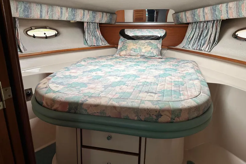 Slide: The Image of Cozy cabin interior of 1992 Regal Commodore 400 with floral bedding and curtains. - 6