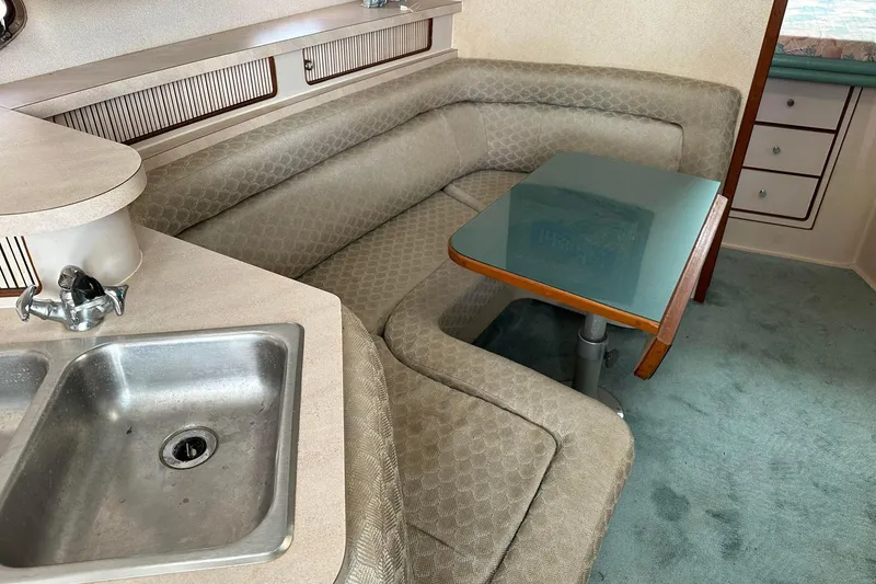 Slide: The Image of 1992 Regal Commodore 400 interior with kitchenette, sink, and cozy seating area. - 8
