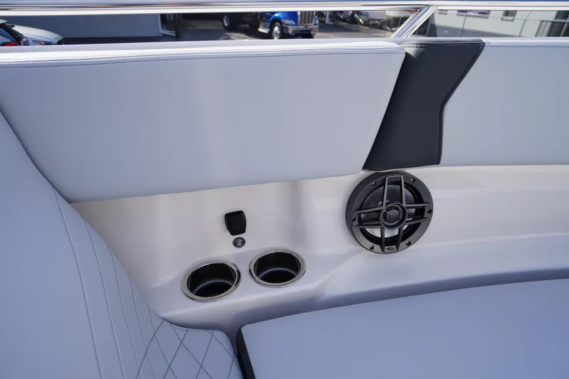 Slide: The Image of 2026 Chaparral 250 OSX boat interior with speaker and cup holders. - 13